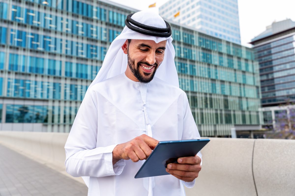 T2G - Arab middle-eastern man wearing emirati kandora traditional clothing in the city - Arabian muslim businessman strolling in urban business centre.