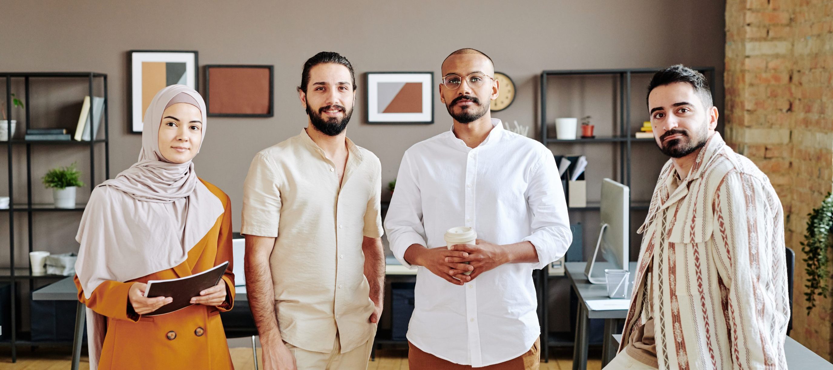 T2G - Group of young Muslim entrepreneurs in casualwear standing in office