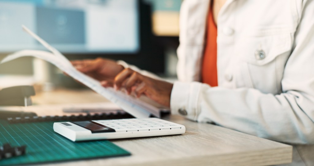 T2G - Hands, document and calculator for accounting in home office for reading, review or tax with remote.