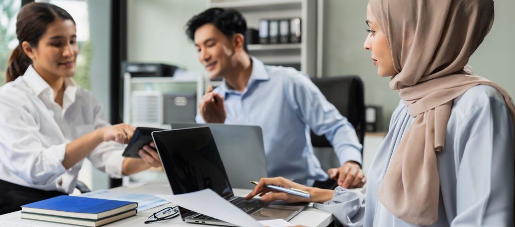 T2G - Mature teammates negotiate in board room, sit at table, exchanging opinions.