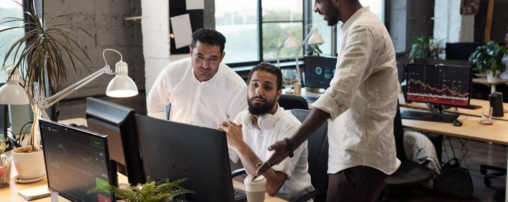 Three intercultural businessmen consulting about working moments
